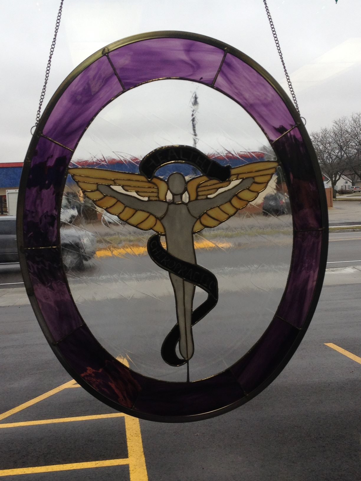 stained glass Chiropractic logo in front window